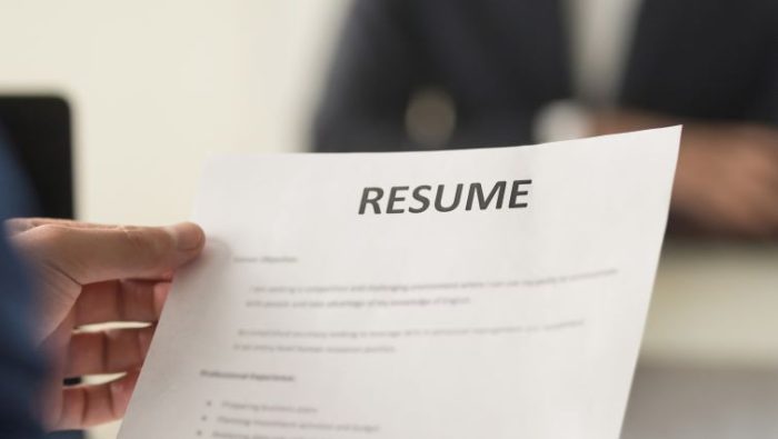 The Targeted Resume - a job seeker handing their targeted resume to a hiring manager.