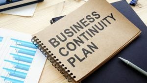 Business Continuity Management 101 - a binder that says "Business Continuity Management" on top of a series of business documents.