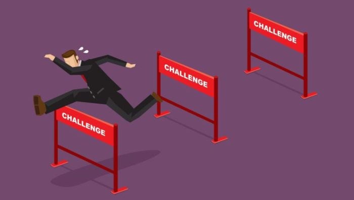 Turning Challenges into Career Opportunities - a business person jumping over hurdles labelled as challenges.